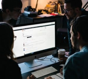 indie developers collaborating while monitoring Reddit discussions